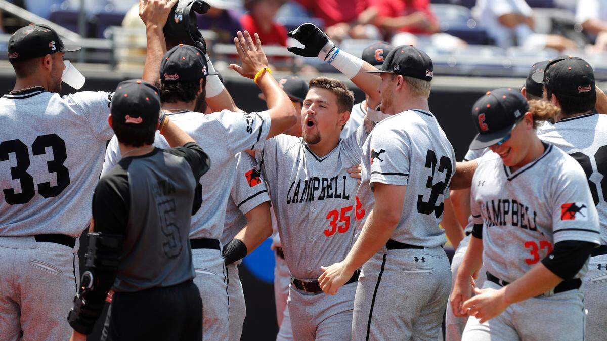 Campbell’s Koby Collins (35) celebrates with teammates after hitting a two-run home run in the first inning during N.C. State’s game against Campbell in the Greenville Regional at Clark-LeClair Stadium in Greenville, N.C., Friday, May 31, 2019.