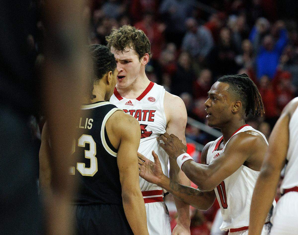 N.C. State’s DJ Horne separates teammate Ben Middlebrooks and Wake Forest’s Hunter Sallis late in the second half of the Wolfpack’s 83-76 win at PNC Arena on Tuesday, Jan. 16, 2024, in Raleigh, N.C.