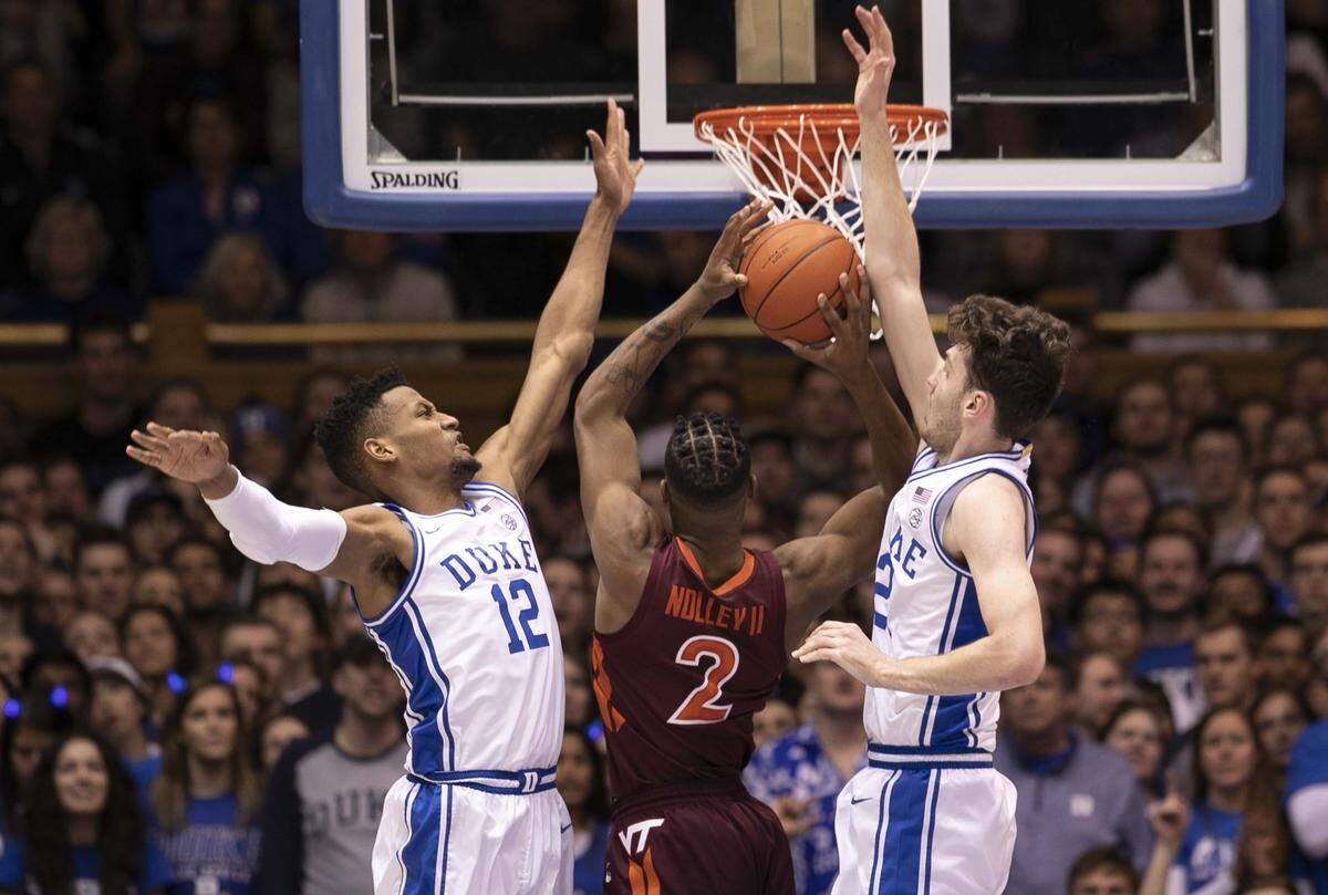 Duke’s Javin DeLaurier (12) and Matthew Hurt (21) defend Virginia Tech’s Landers Nolley II (2) during the first half on Saturday, February 22, 2020 at Cameron Indoor Stadium in Durham, N.C.