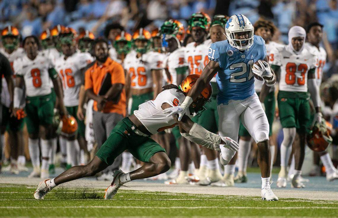 North Carolinas Elijah Green (21) breaks away from Florida A&Ms Timothy Williams Jr. (6) for a 46-yard gain in the fourth quarter on Saturday, August 27, 2022 at Kenan Stadium in Chapel Hill, N.C.