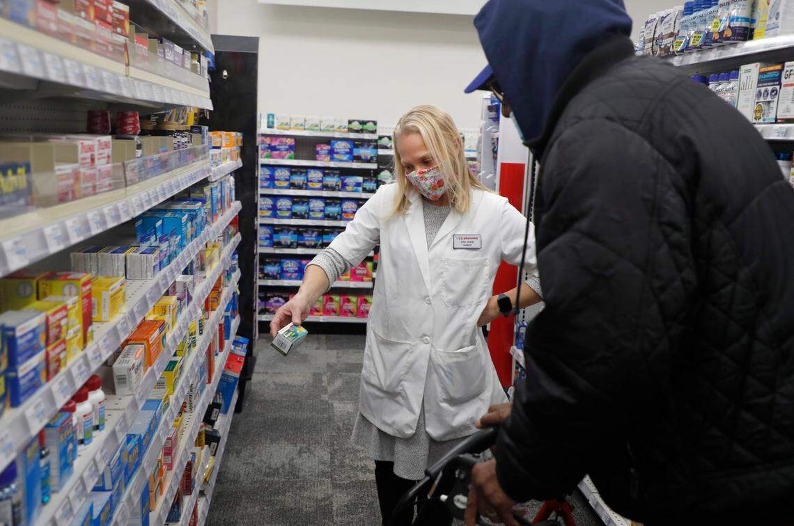 Pharmacist April Gorski helps Billie Banks find aspirin at the CVS on Fayetteville St. in downtown Raleigh, N.C., Friday, February 5, 2021. The store reopened this week after being closed since the end of May after it was looted after protests in downtown Raleigh.