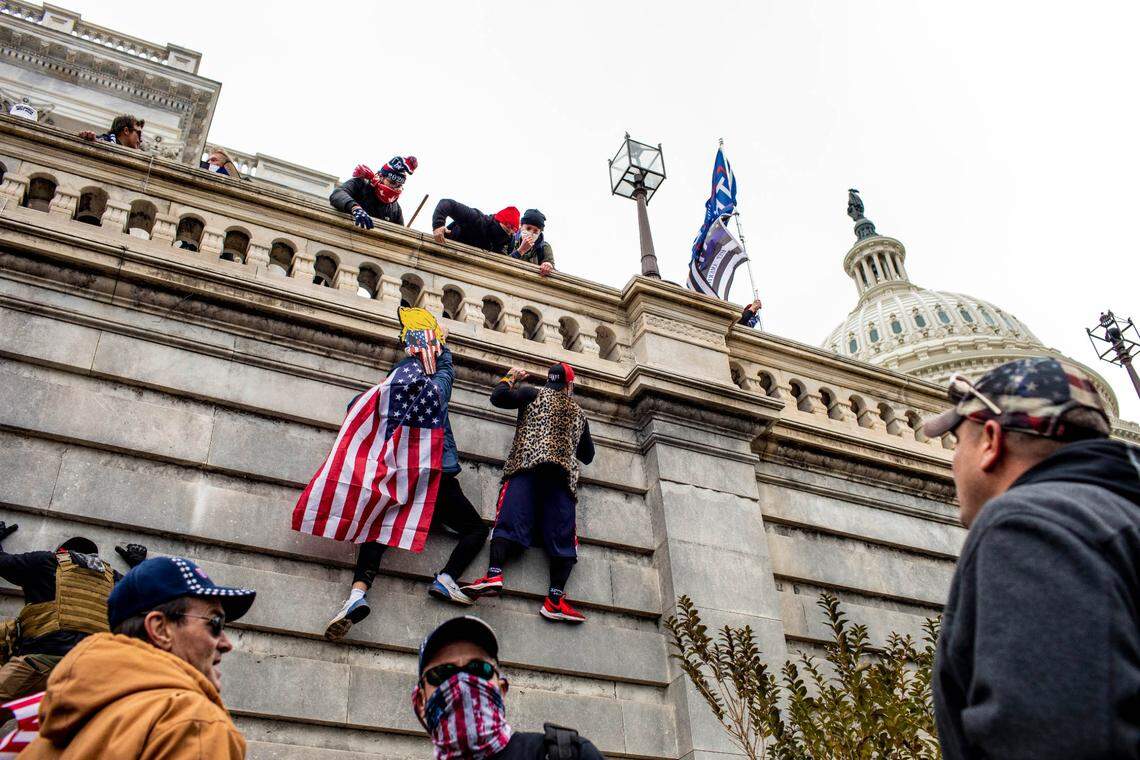 Protestors climb the Capitol in Washington on Wednesday, Jan. 6, 2021. The Capitol building was placed on lockdown, with senators and members of the House locked inside their chambers, as Congress began debating President-elect Joe Biden’s victory. President Trump addressed supporters near the White House before protesters marched to Capitol Hill. (Jason Andrew/The New York Times)