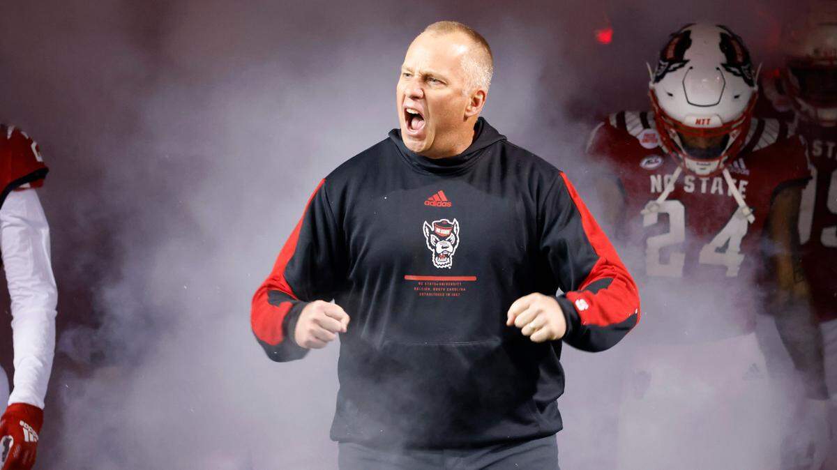 N.C. State head coach Dave Doeren is pumped as he heads onto the field before N.C. State’s game against UNC at Carter-Finley Stadium in Raleigh, N.C., Friday, November 26, 2021.