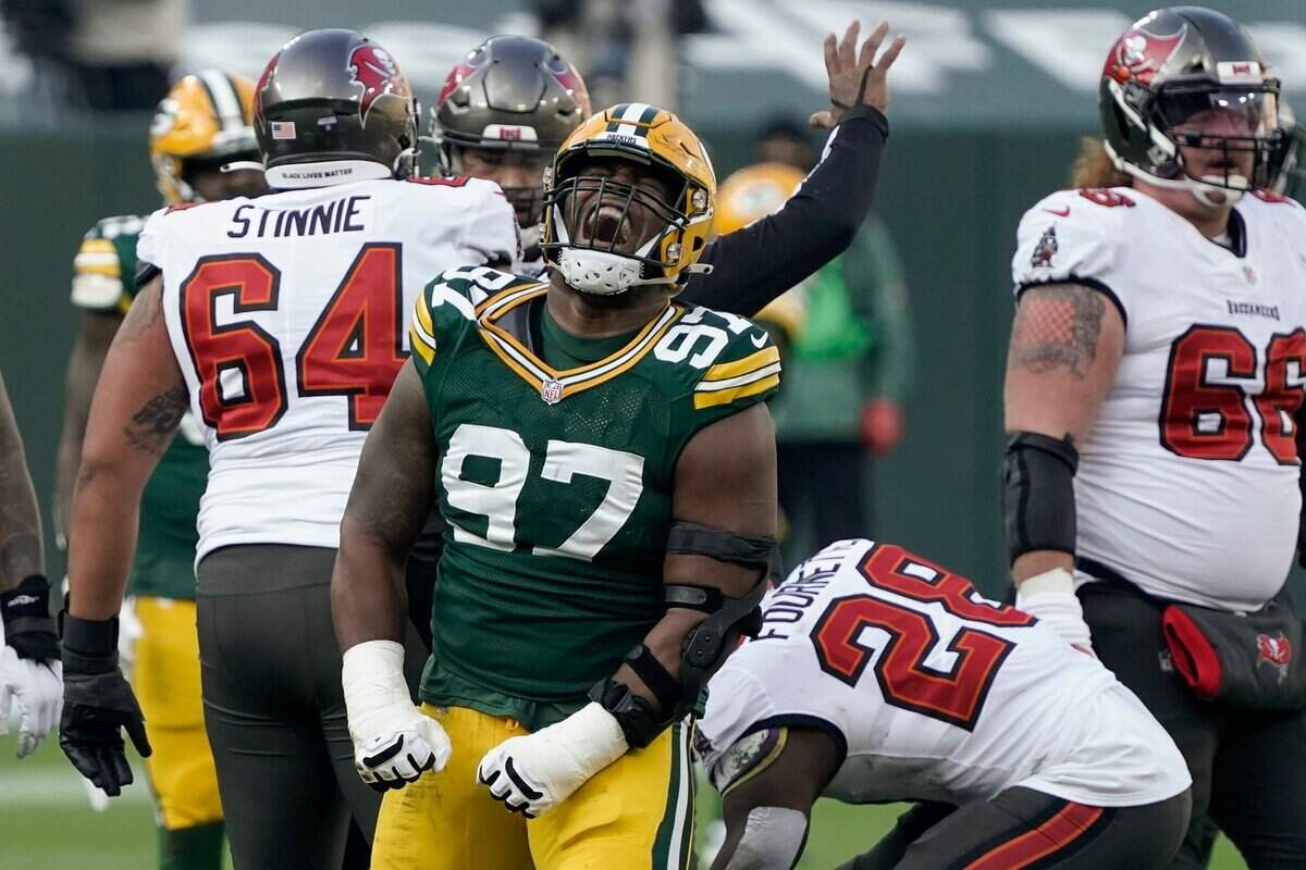 Green Bay Packers’ Kenny Clark (97) reacts after sacking Tampa Bay Buccaneers quarterback Tom Brady during the first half of the NFC championship NFL football game in Green Bay, Wis., Sunday, Jan. 24, 2021.