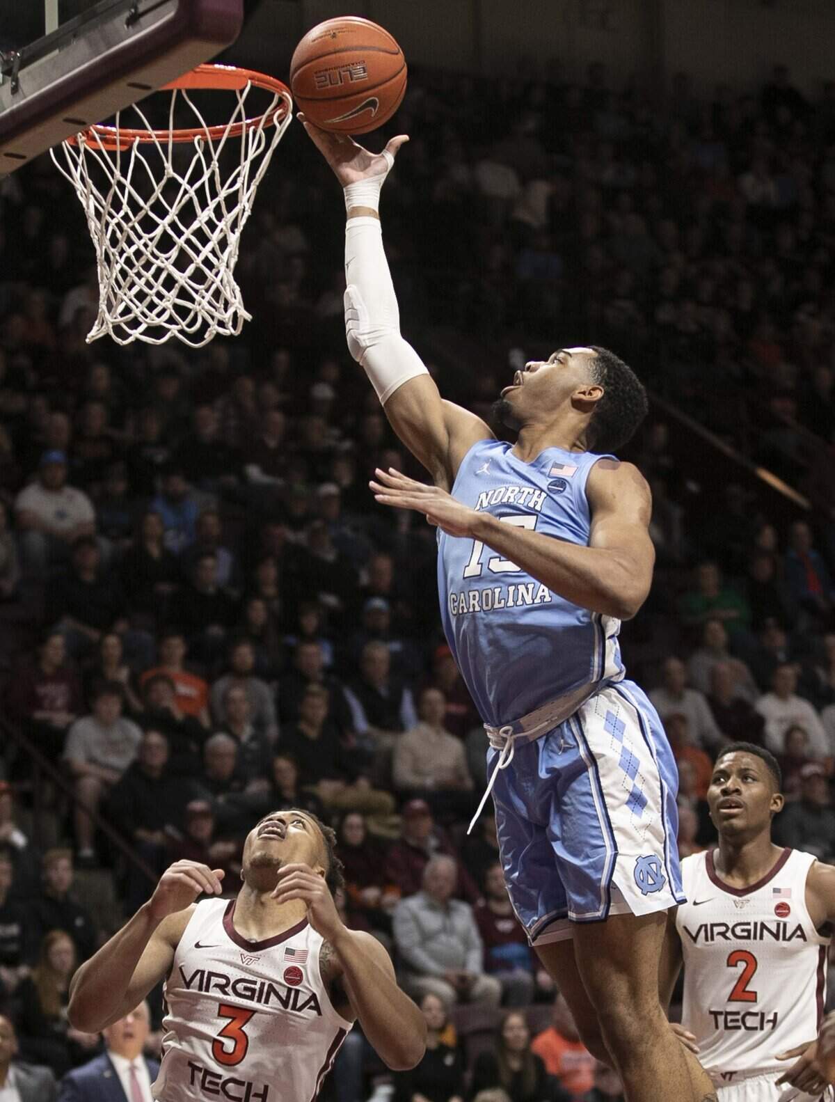 North Carolina’s Garrison Brooks (15) puts up a shot over Virginia Tech’s Landers Nolley II (2) and Wabissa Bede (3) during the first half on Wednesday, January 22, 2020 at Cassell Coliseum in Blacksburg, Va.