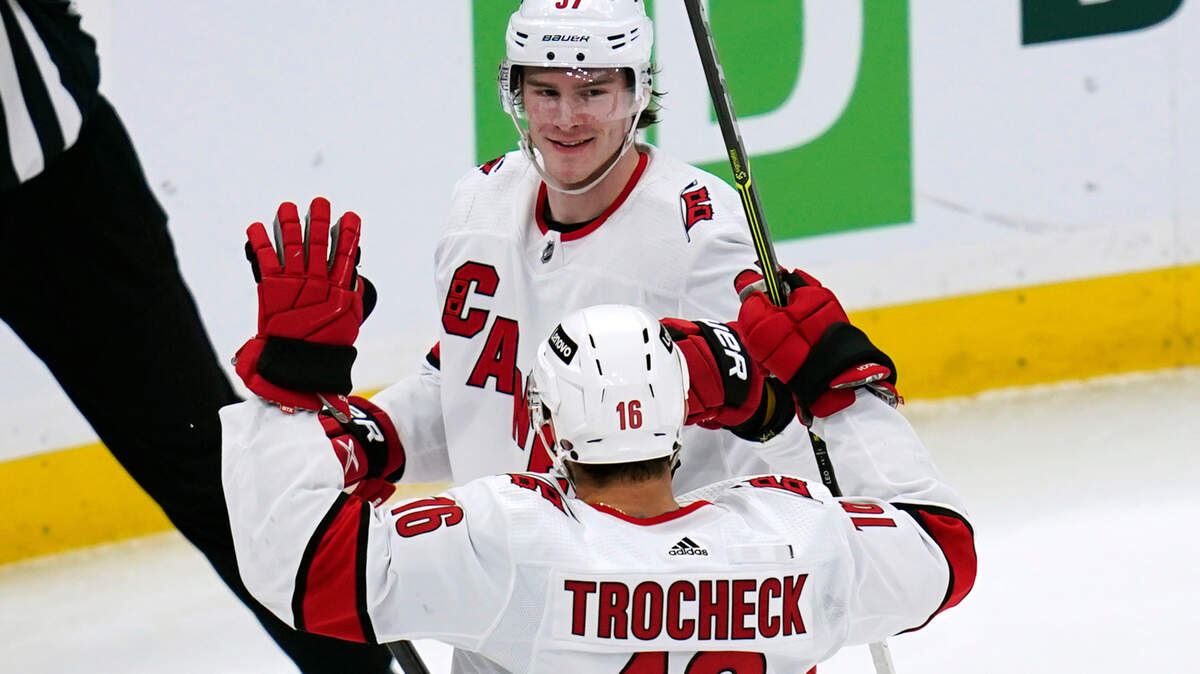 Carolina Hurricanes right wing Andrei Svechnikov (37) celebrates with center Vincent Trocheck after Svechnikov’s goal against the Boston Bruins during the third period Tuesday, Jan. 18, 2022, in Boston. (AP Photo/Charles Krupa)