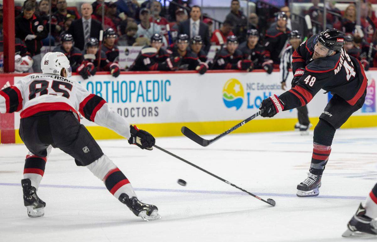 The Carolina Hurricanes Jordan Martinook (48) takes a shot on the Ottawa Senators goalie Joonas Korpisalo (70) in the first period on Wednesday, October 11, 2023 at PNC Arena, in Raleigh N.C.