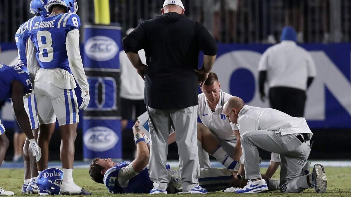 Duke head coach Mike Elko stands next to quarterback Riley Leonard after he suffered an injury late in the fourth quarter of the Blue Devils’ 21-14 loss to Notre Dame at Wallace Wade Stadium on Saturday, Sept. 30, 2023, in Durham, N.C.