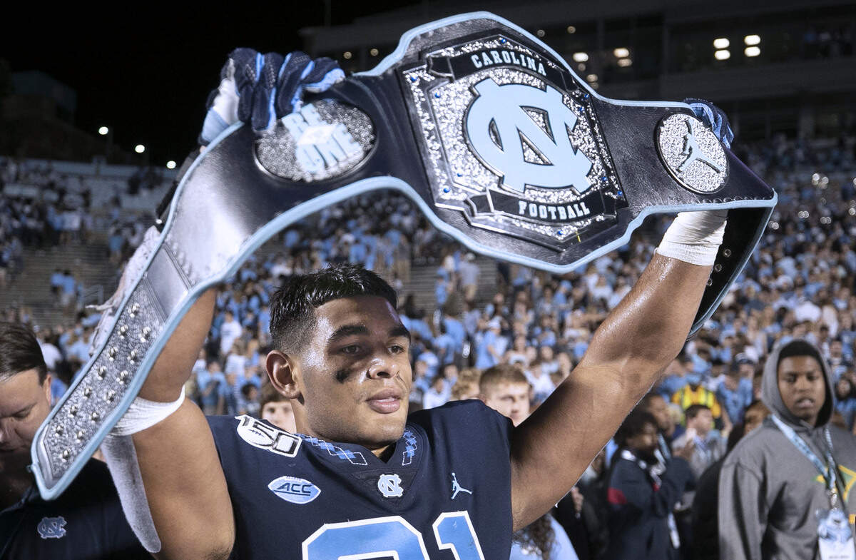 North Carolina linebacker Chazz Surratt (21) celebrates with the turnover belt after he intercepted a Deon Jackson pass with :14 seconds to play to secure the Tar Heels’ 20-17 victory over Duke on Saturday, October 26, 2019 at Kenan Stadium in Chapel Hill, N.C.