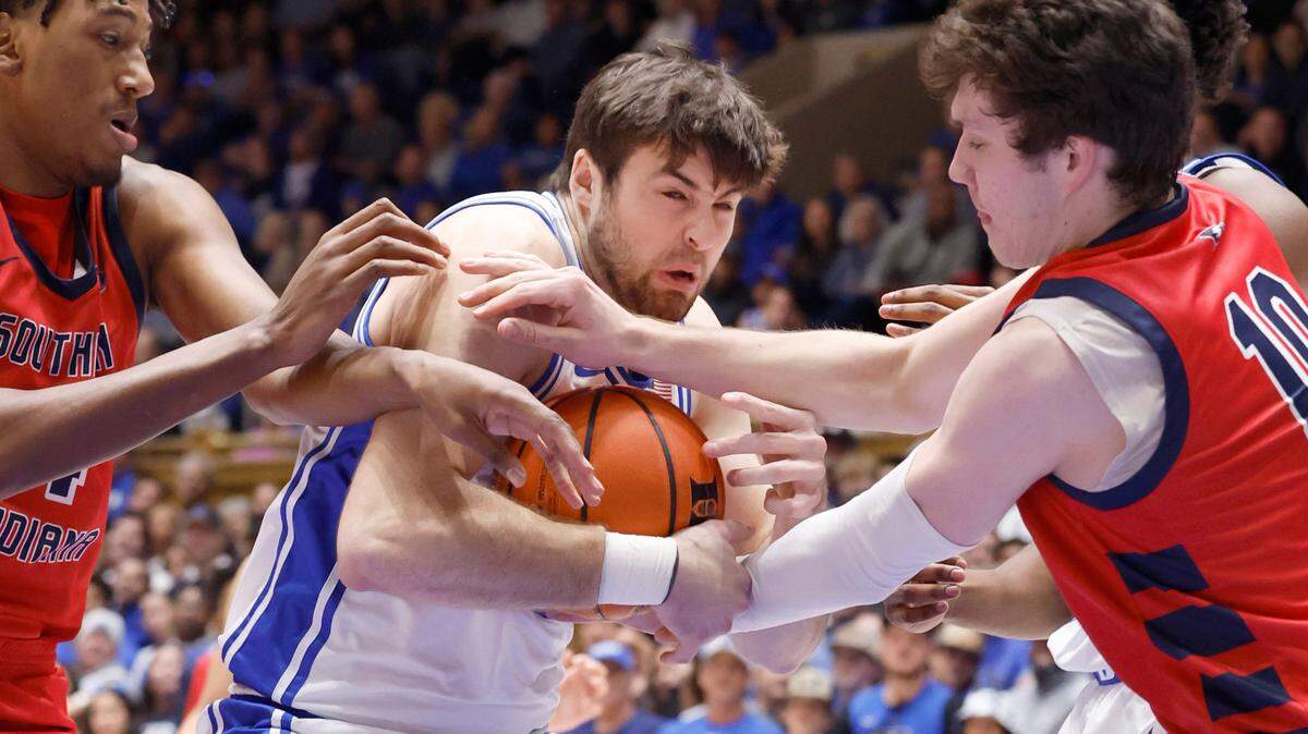 Duke’s Ryan Young (15) keeps the ball from Southern Indiana’s Nolan Causwell (4), left and Jack Mielke (10) during the first half of Duke’s game against Southern Indiana at Cameron Indoor Stadium in Durham, N.C., Friday, Nov. 24, 2023.