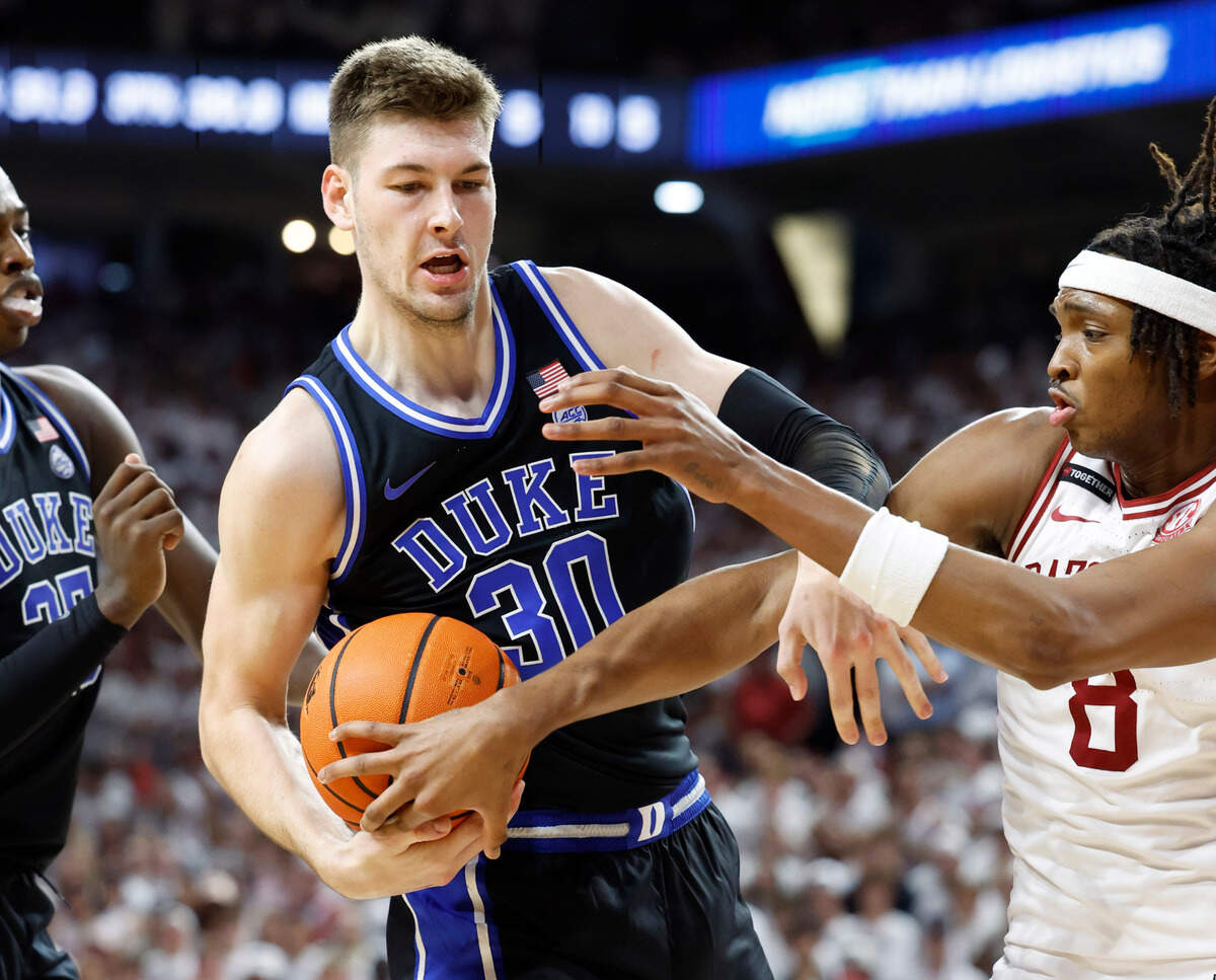 Duke’s Kyle Filipowski (30) fights for a rebound with Arkansas’ Chandler Lawson (8) during the second half of Arkansas’ 80-75 victory over Duke at Bud Walton Arena in Fayetteville, Ark., Weds. Nov. 29, 2023.