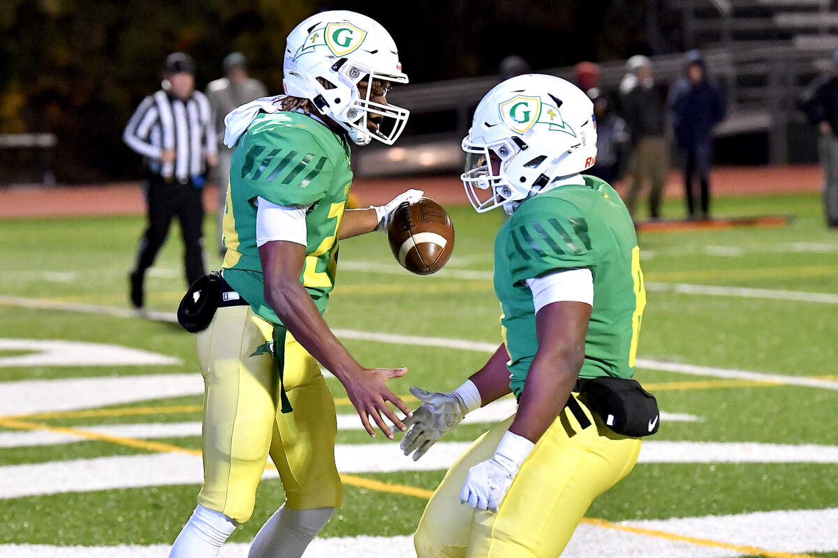 Cardinal Gibbons’ running back Aaron Anderson (28) , left, celebrates his touchdown against Hillside with Noah Terry (8) during the second half. The Cardinal Gibbons Crusaders and the Durham Hillside Hornets met in the third round of the NCHSAA 4A playoffs in Raleigh, N.C. on November 29, 2024.