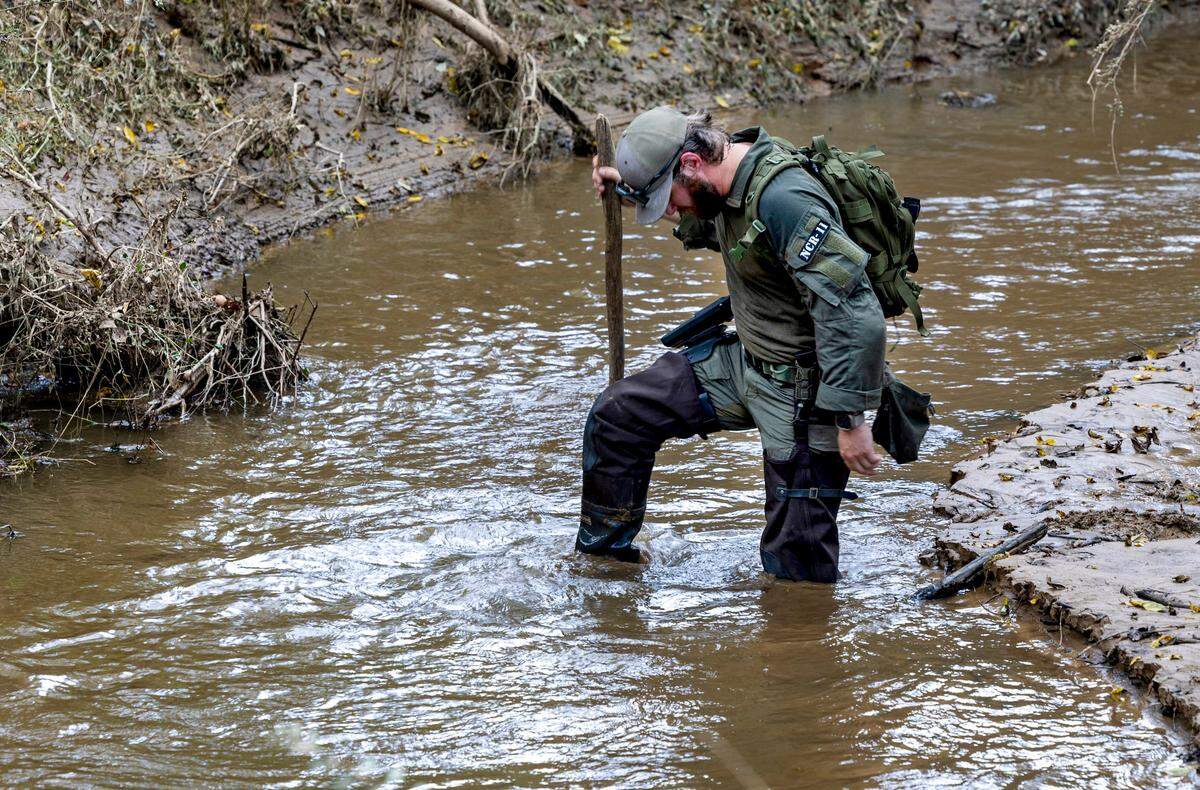 A member of a search and rescue team wades into the Catawba River searching for victims of Hurricane Helene on Wednesday, October 2, 2024 near Old Fort, N.C.