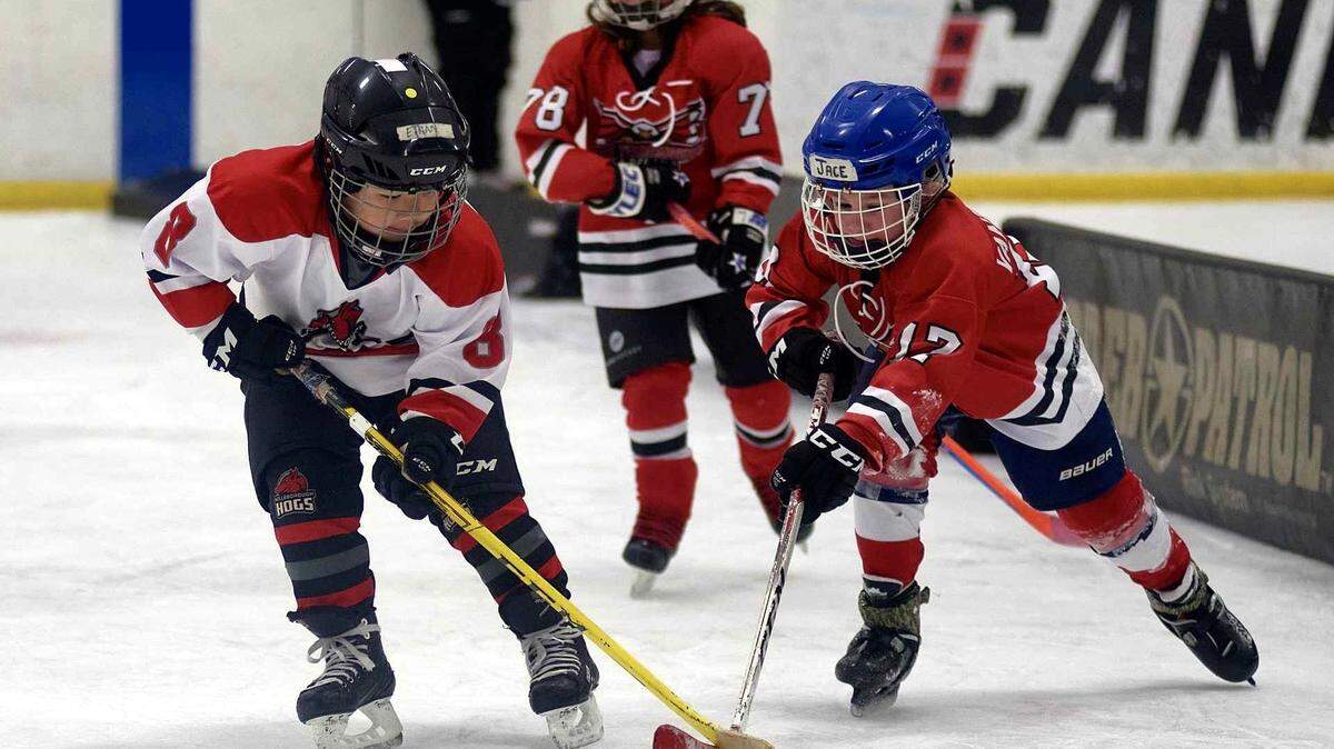 Some of the Hillsborough Hogs’ youngest players fight for control of the puck during a practice game at the SportsPlex in Orange County.
