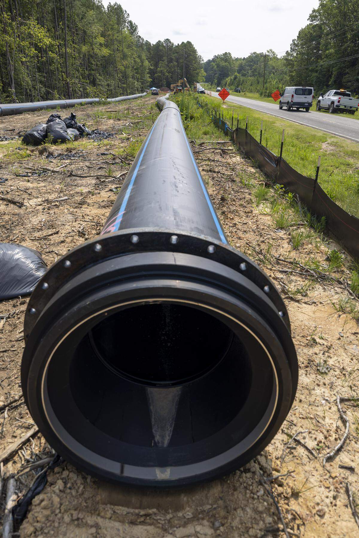 The first stages of a pipeline are being installed along Poplar Springs Road in Sanford, N.C. on Wednesday, July 9, 2025, that will carry water from the TriRiver Water plant to Moncure in Chatham County. The pipeline will eventually extend from Moncure to Pittsboro to service the expansion of Chatham Park. 