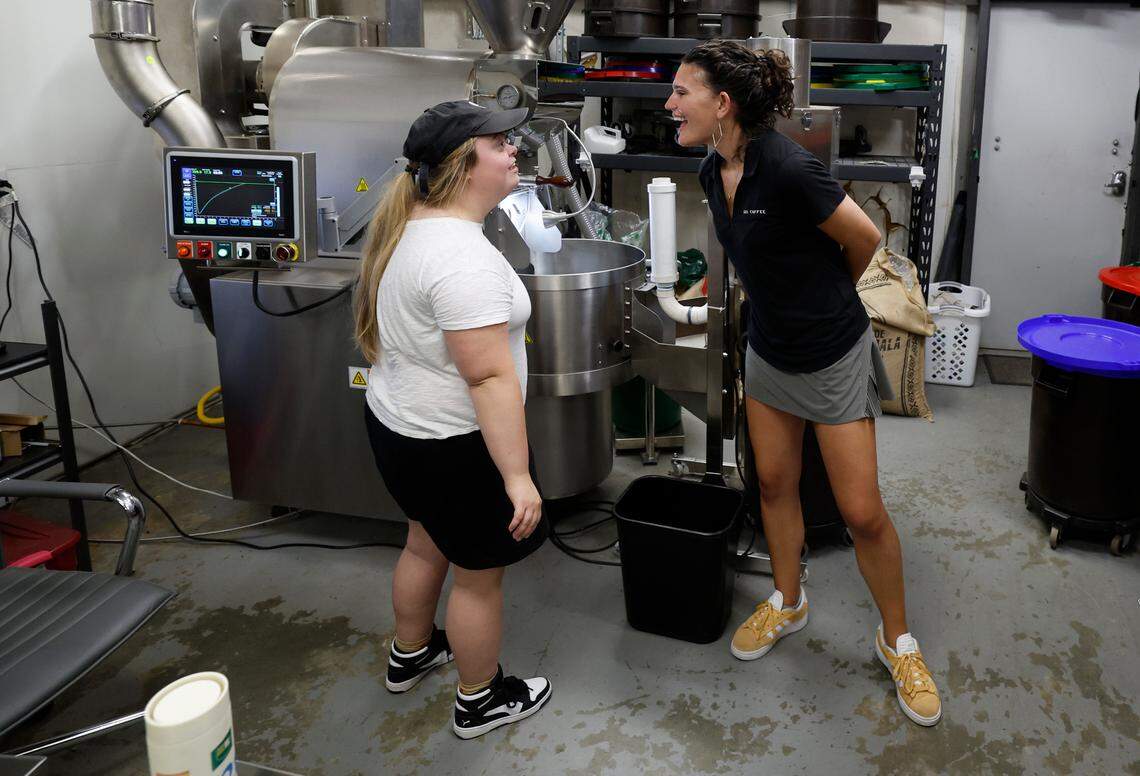 Sophie Pacyna, left, laughs with Lindsay Wrege at the 321 Coffee roasting facility in Raleigh, N.C., Tuesday, June 25, 2024.