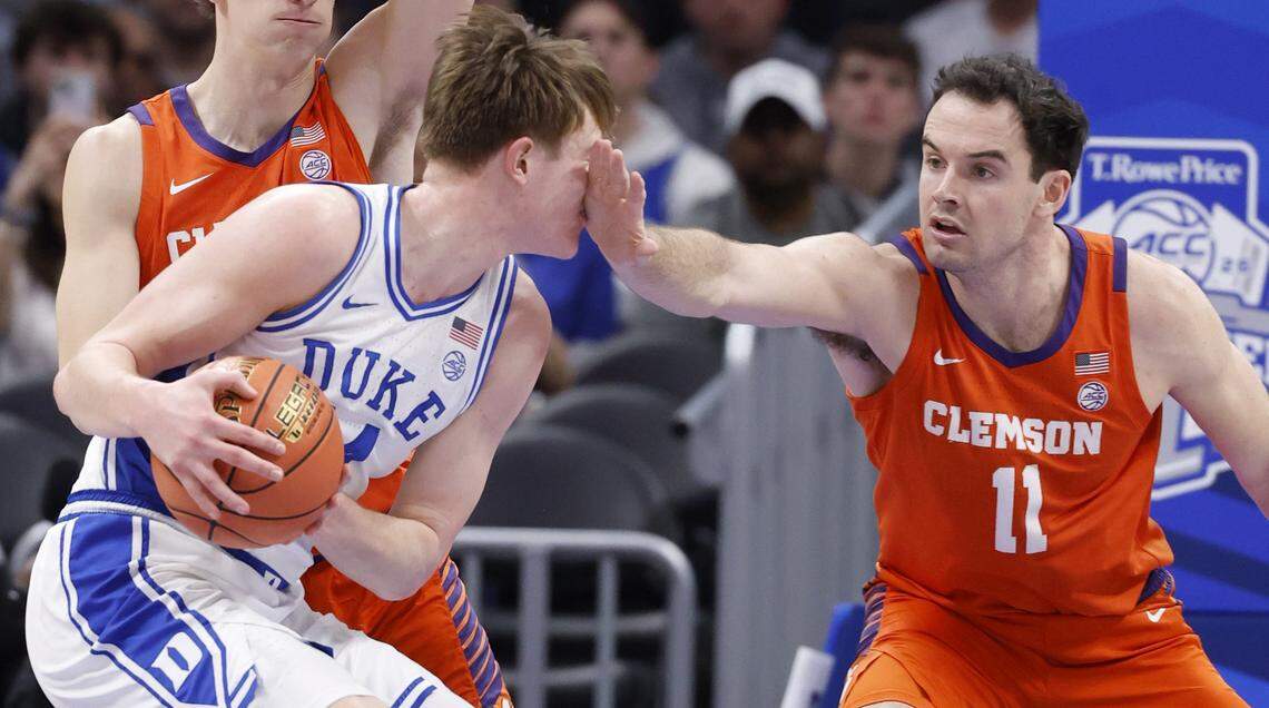 Clemson's Nick Davidson (11) defends Duke’s Nikolas Khamenia II (14) during the first half of Duke’s game against Clemson in the semifinals of the 2026 ACC Men’s Basketball Tournament at the Spectrum Center in Charlotte, N.C., Friday, March 13, 2026.