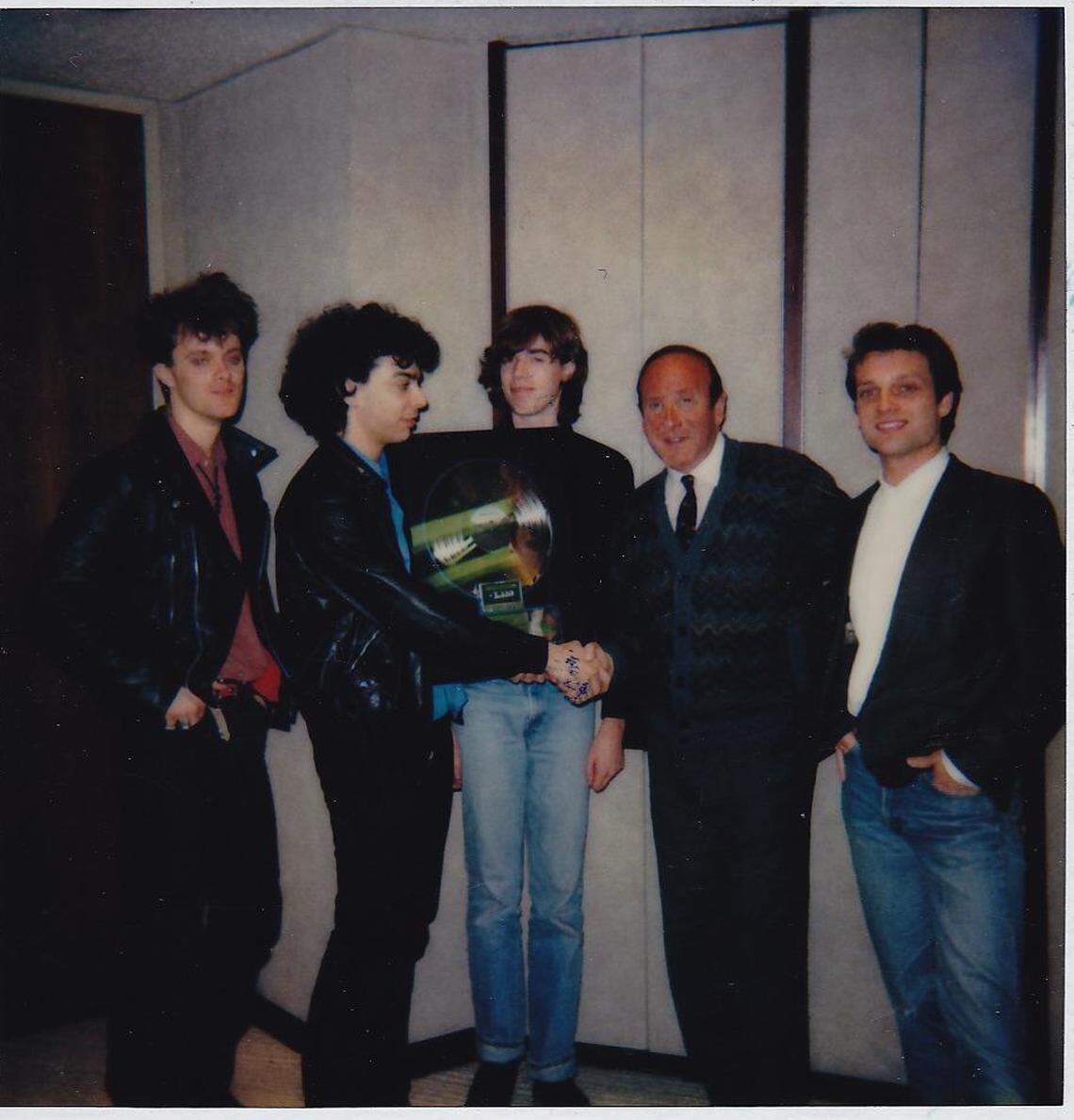 The Right Profile at their 1986 signing ceremony. From left, Jeffrey Dean Foster, Stephen Dubner, Jon Wurster, Arista Records president Clive Davis and Tim Fleming.