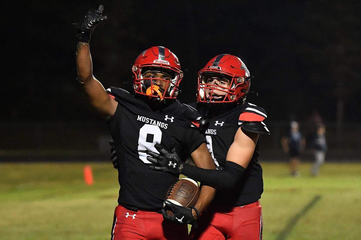 Middle Creek’s Malachi Biggs (8) celebrates his two-point conversion catch against Apex Friendship with Garett Sladek (4) late in the fourth quarter. The Middle Creek Mustangs and the Apex Friendship Patriots met in a football game in Cary, N.C. on October 25, 2024.