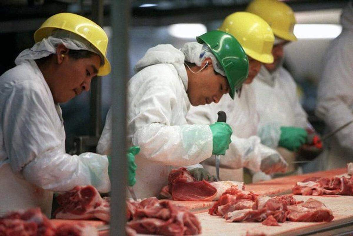 “Picnic line” workers cut pork from shoulder bones in the Smithfield Foods processing plant in Tar Heel. The company is moving its Charlotte operations to the facility in Bladen County.