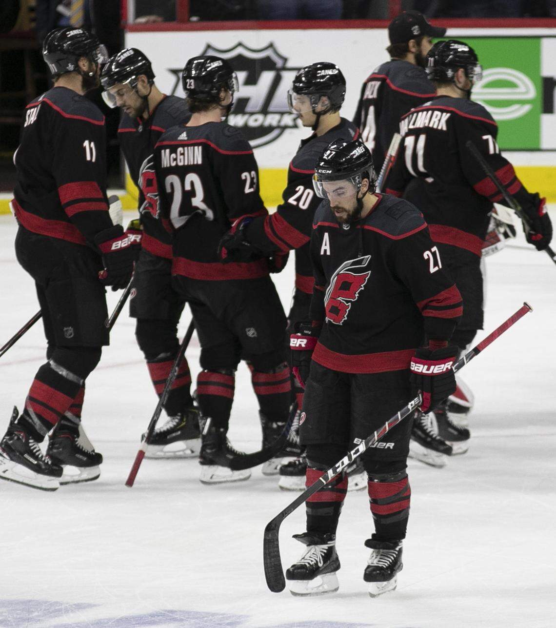 Carolina Hurricanes’ Justin Faulk (27) skates away from his teammates as the Boston Bruins celebrate their Eastern Conference championship sweeping the Hurricanes 4-0 on Thursday, May 16, 2019 at PNC Arena in Raleigh, N.C.