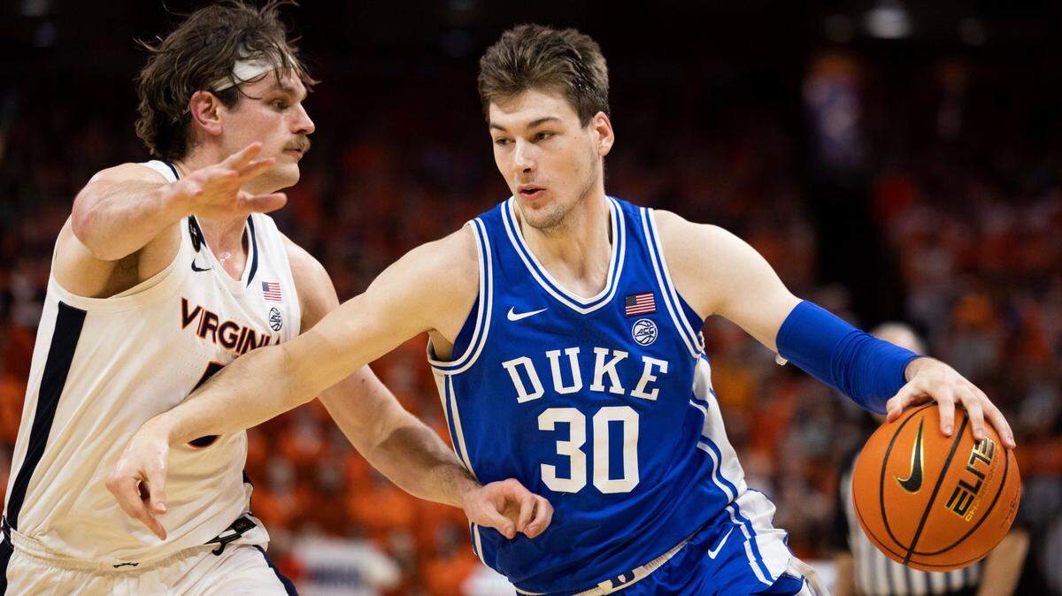 Duke’s Kyle Filipowski (30) defends the ball against Virginia’s Ben Vander Plas (5) during the first half of an NCAA college basketball game in Charlottesville, Va., Saturday, Feb. 11, 2023. (AP Photo/Mike Kropf)