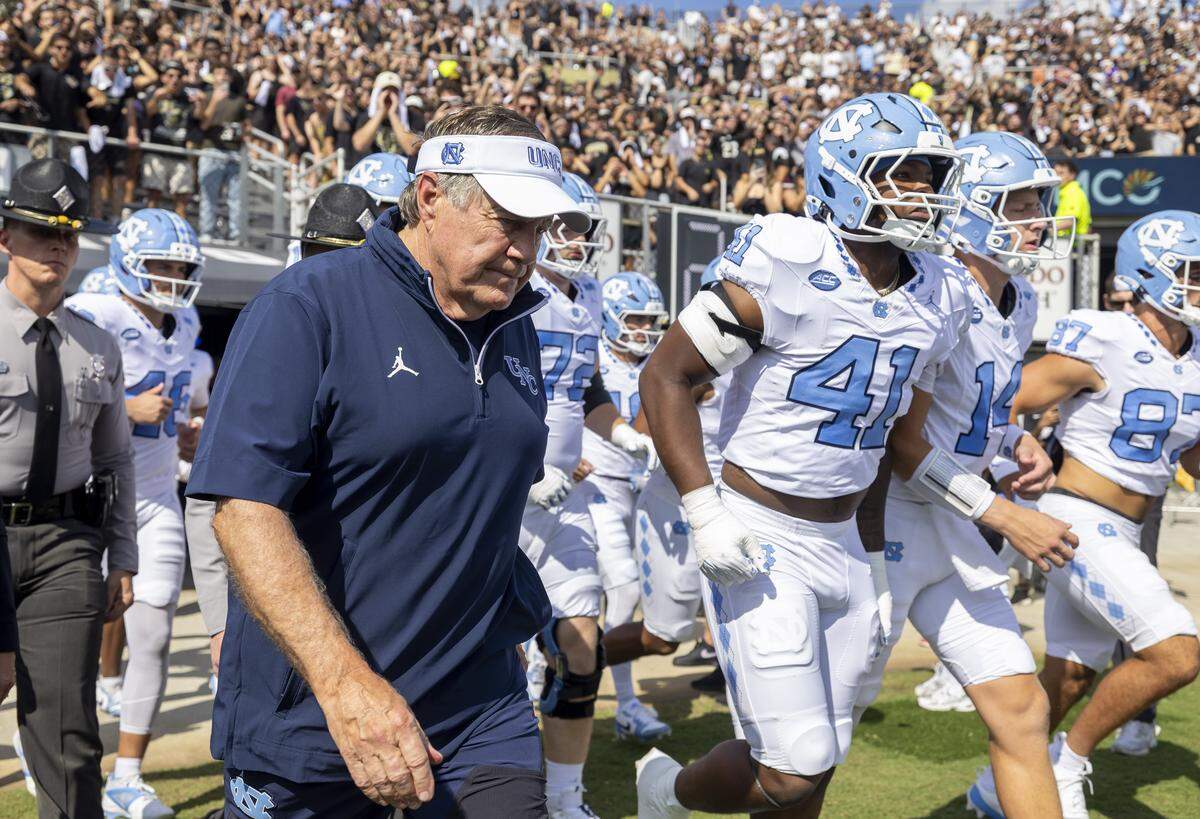 North Carolina coach Bill Belichick enters the field with his players for the Tar Heels’ game against UCF on Saturday, September 20, 2025 at Acrisure Bounce House Stadium in Orlando, Fla. 