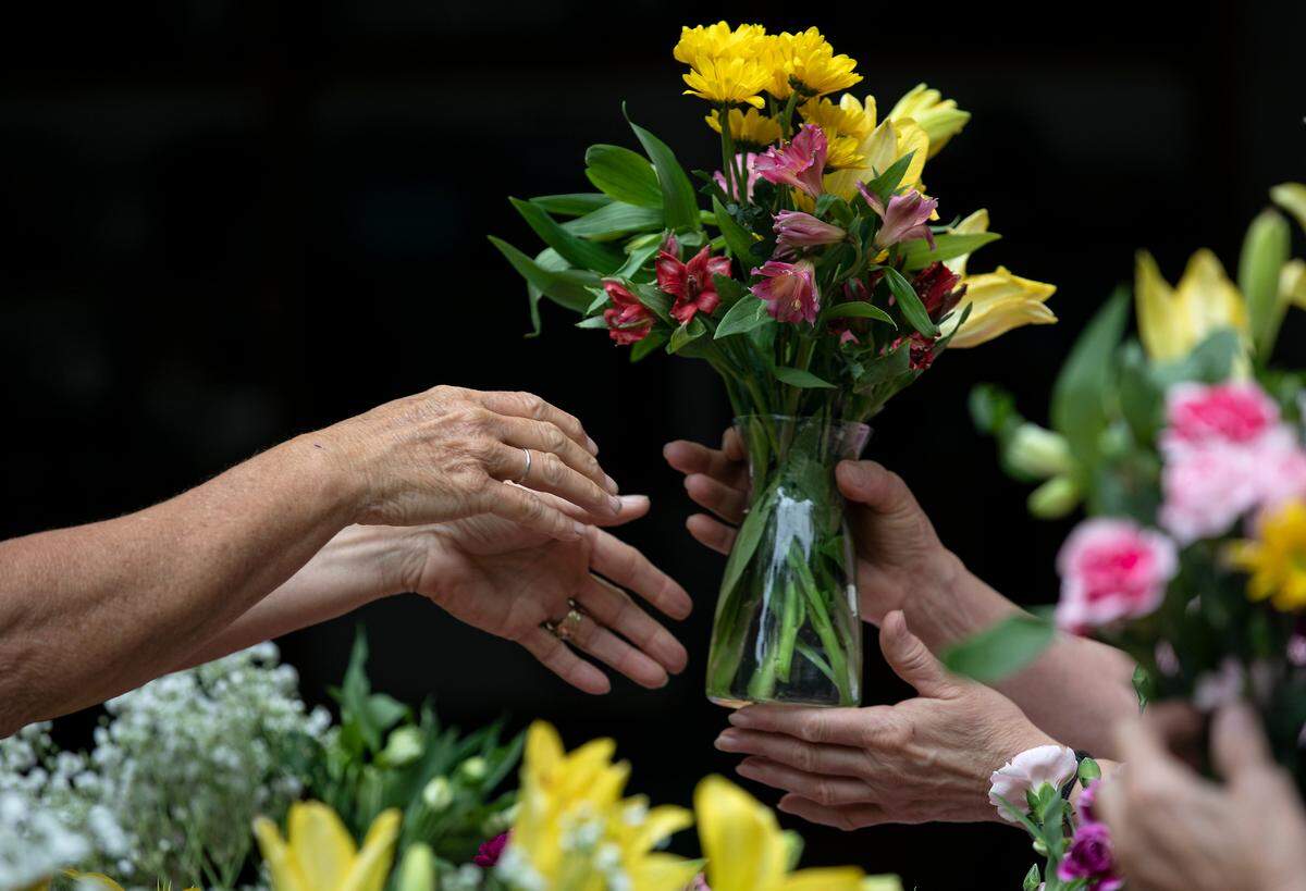 A group of women prepare Mother’s Day flower arrangements on Friday, May 6, 2022, in Cary, N.C.