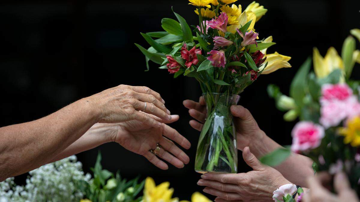 A group of women prepare Mother’s Day flower arrangements on Friday, May 6, 2022, in Cary, N.C.