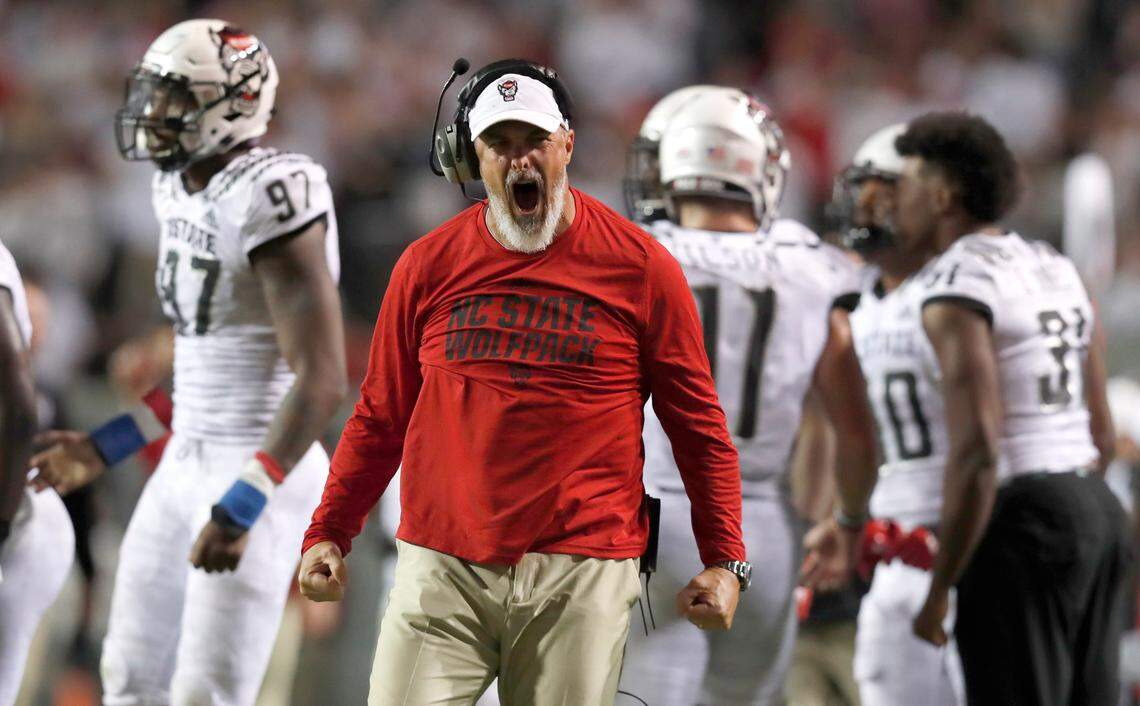 N.C. State defensive line coach Kevin Patrick celebrates a Wolfpack sack during the first half of N.C. State’s game against Syracuse at Carter-Finley Stadium in Raleigh, N.C., Thursday, Oct. 10, 2019.
