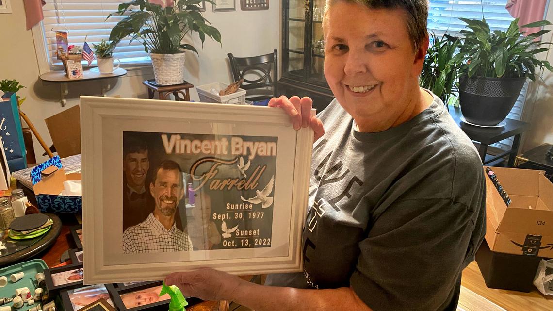 Patricia Farrell of Durham holds up memorial plaque of her late son, Vincent, who died while at work at Wolfspeed.