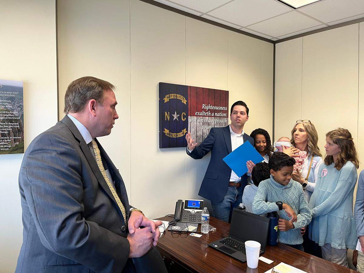 Rep. Neal Jackson, a Randolph County Republican, speaks with families who support a six-week abortion ban in his office at the Legislative Office Building in Raleigh, N.C. on Tuesday, Feb. 28, 2023.
