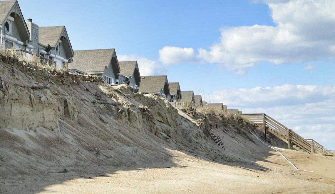 Beach erosion near a line of ocean-front houses in Southern Shores, N.C..