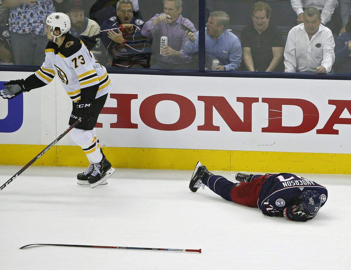 Boston Bruins defenseman Charlie McAvoy (73) knocked Columbus Blue Jackets right wing Josh Anderson (77) down to the ice after a hit to the head in the second period during Game 6 of the NHL Stanley Cup Playoffs Eastern Conference semifinals at Nationwide Arena on May 6, 2019 in Columbus, Ohio. The Bruins won, 3-0.