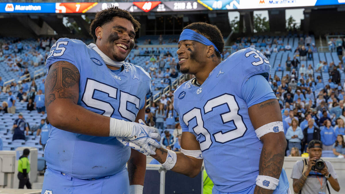 North Carolina’s Cedric Gray (33) and teammate Zach Rice (55) celebrate the Tar Heels’ 40-7 victory over Syracuse on Saturday, October 7, 2023 at Kenan Stadium in Chapel Hill, N.C.