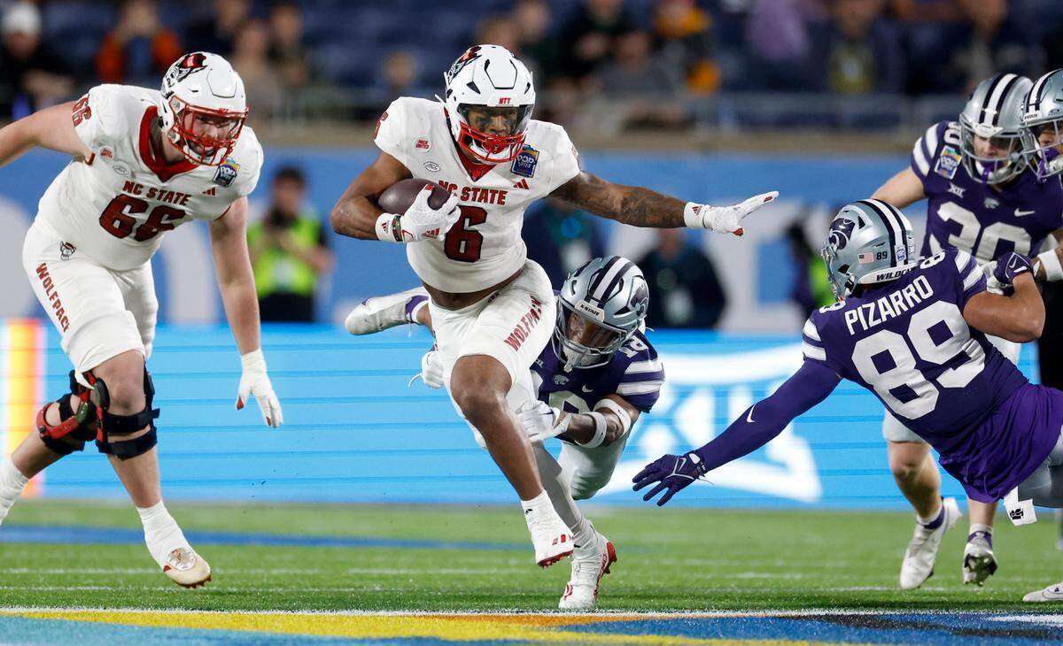 N.C. State’s Trent Pennix (6) breaks free to score on a 60-yard fake punt during the second half of Kansas State’s 28-19 victory over N.C. State in the Pop-Tarts Bowl at Camping World Stadium in Orlando, Fla., Thursday, Dec. 28, 2023.
