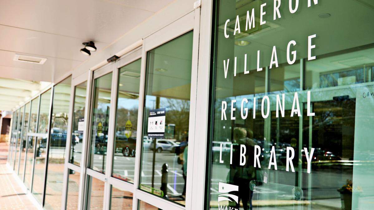 This file photo shows the Cameron Village Regional Library’s old name on the door before it was changed in March 2021 to Village Regional Library. It’s the Wake County Public Library system’s largest regional branch.