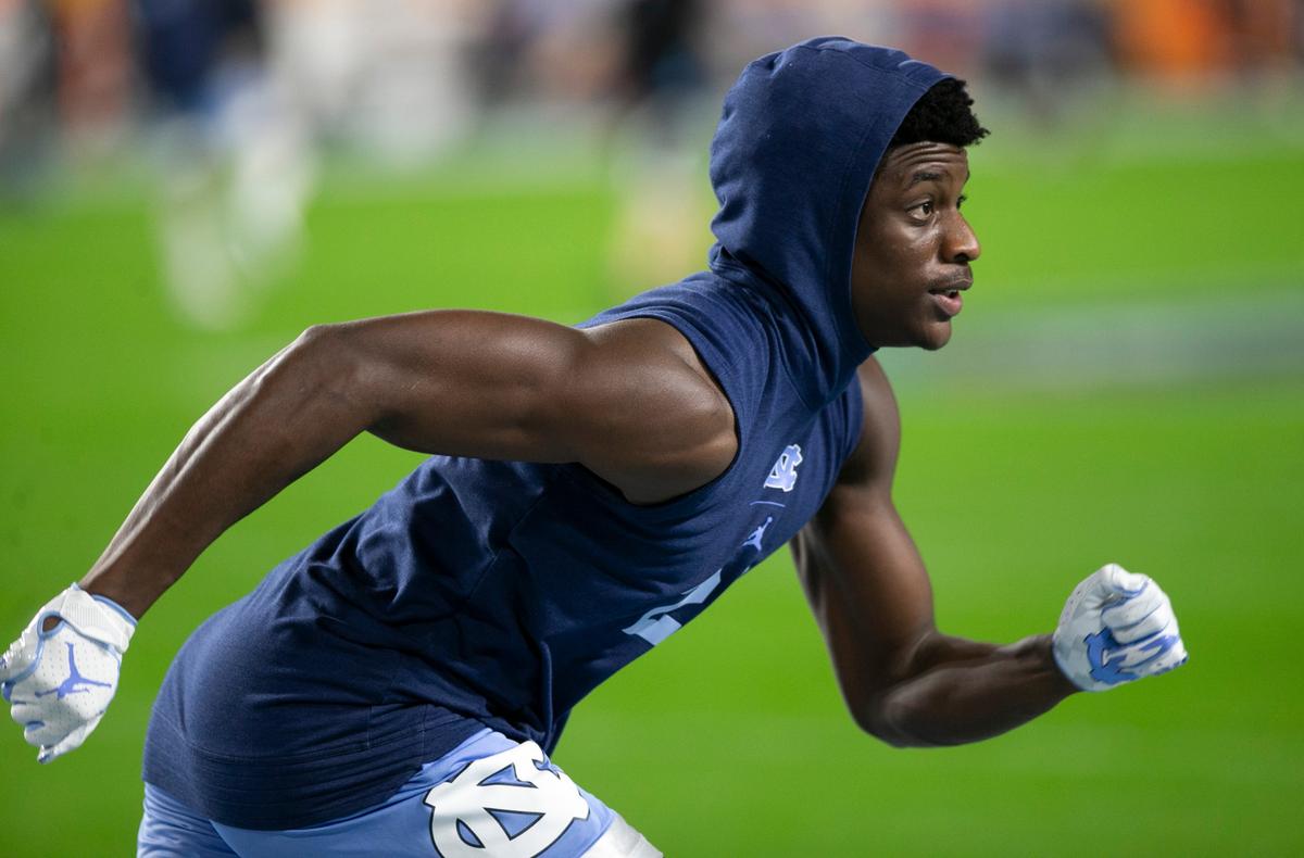 North Carolina defensive back Tony Grimes (20) warms up with his teammates for their game against Texas A&M on Saturday, January 2, 2021 at the Orange Bowl in Miami Gardens, Florida.