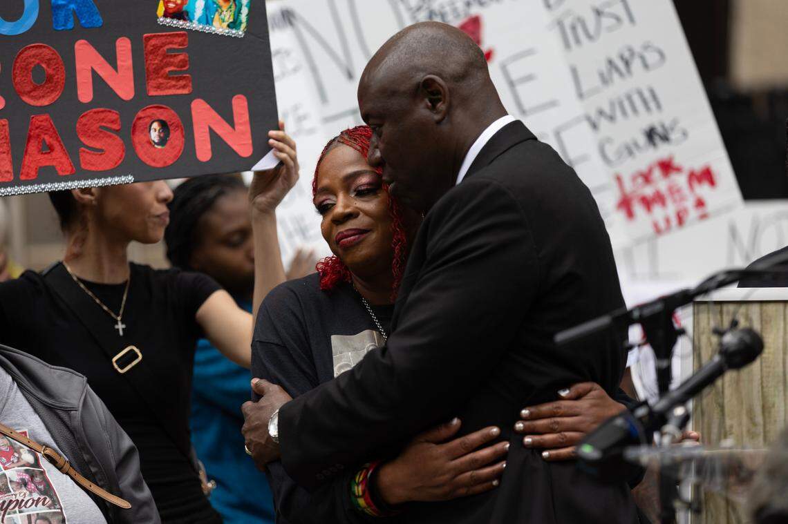 Henrietta Mason, mother of Tyrone Mason who was killed in a car crash in October 2024, holds the hand of attorney Ben Crump during a rally outside the Wake County Courthouse in Raleigh, N.C. on Thursday, May 29, 2025.