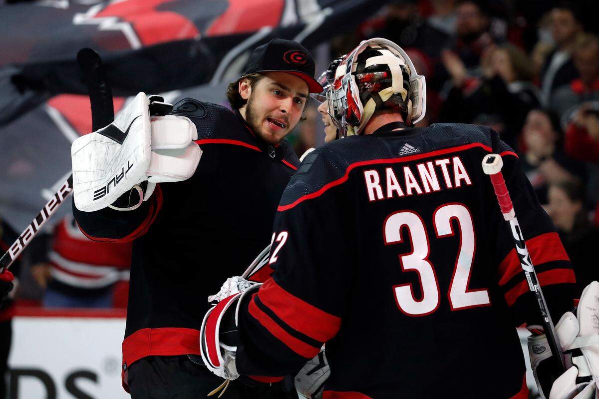 Carolina Hurricanes goaltender Pyotr Kochetkov, left, congratulates teammates goaltender Antti Raanta (32) on his win over the Boston Bruins following Game 5 of an NHL hockey Stanley Cup first-round playoff series in Raleigh, N.C., Tuesday, May 10, 2022. (AP Photo/Karl B DeBlaker)