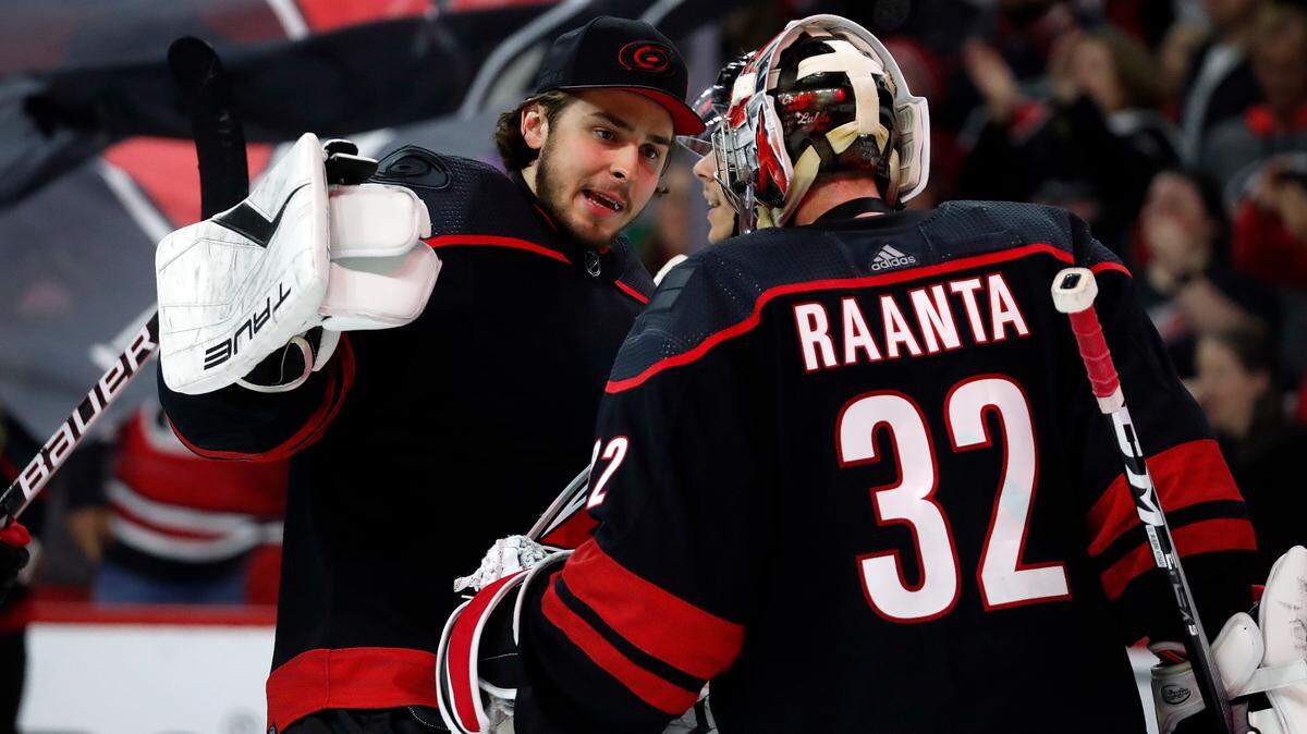 Carolina Hurricanes goaltender Pyotr Kochetkov, left, congratulates teammates goaltender Antti Raanta (32) on his win over the Boston Bruins following Game 5 of an NHL hockey Stanley Cup first-round playoff series in Raleigh, N.C., Tuesday, May 10, 2022. (AP Photo/Karl B DeBlaker)