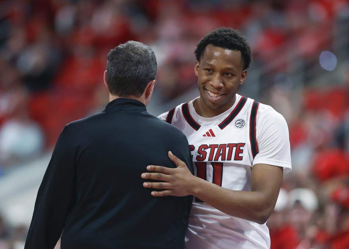 N.C. State’s Quadir Copeland hugs head coach Will Wade as he exits the game during the second half of the Wolfpack’s 110-64 win over UNC Greensboro on Wednesday, Nov. 12, 2025, at Lenovo Center in Raleigh, N.C.