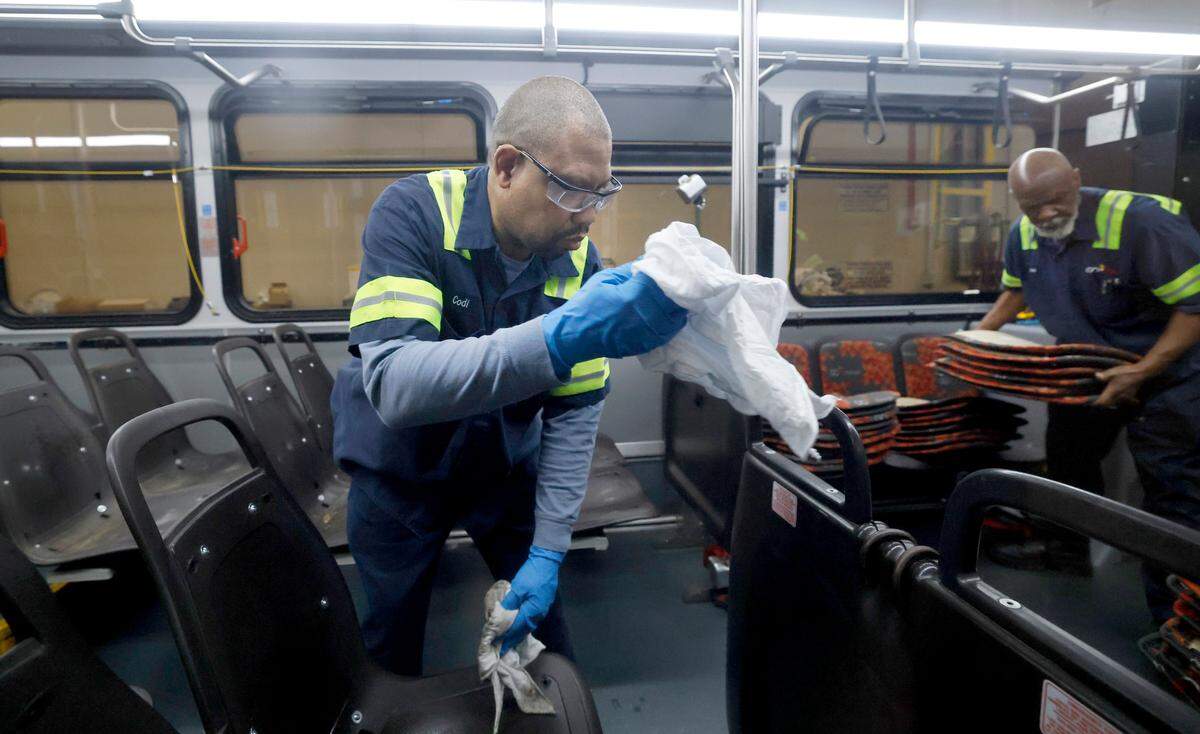 Cody Lee cleans a bare seat frame after cloth seats were removed on a GoRaleigh bus at GoRaleigh’s maintenance headquarters off Poole Road on May 10, 2025. Lee and Daniel Moore were taking out the old seat backs and bottoms and installing new vinyl ones.