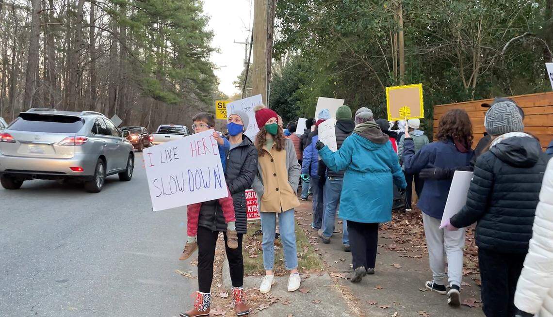 Well over 100 Chapel Hill residents gathered Friday evening, Jan. 7, 2022, at a crosswalk in front of Phillips Middle School on Estes Drive to raise awareness of pedestrian safety. The walk was prompted by a wreck Dec. 31, 2021, that injured two middle school students.