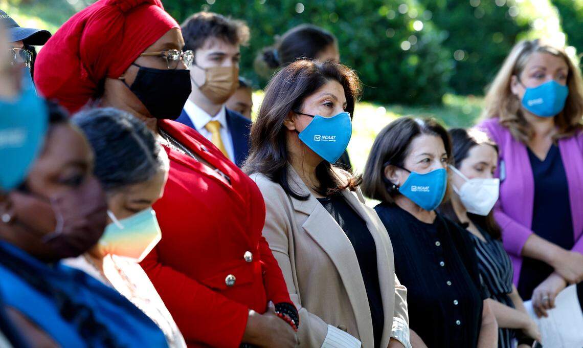 Shruti Parikh, center, head of Education and Political Engagement of North Carolina Asian Americans Together and others listen during a press conference against House Bill 237, the anti-mask and campaign finance bill, outside the Legislative Building in Raleigh, N.C., Tuesday, June 11, 2024.