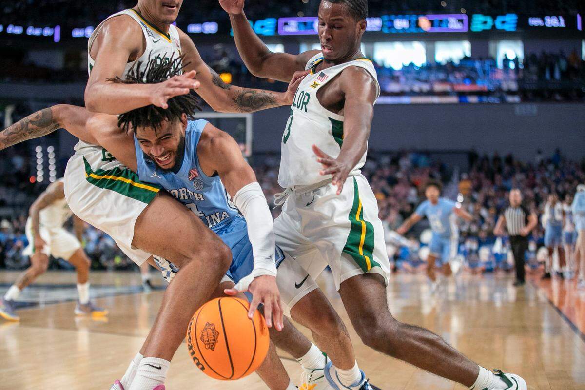 Baylorís Jeremy Sochan (1) and Dale Bonner (3) trap North Carolinaís R.J. Davis (4) in the backcourt during the second half, as Baylor cuts into the Tar Heelsí lead on Saturday, March 19, 2022 during the NCAA Tournament at Dickies Arena in Ft. Worth, TX.