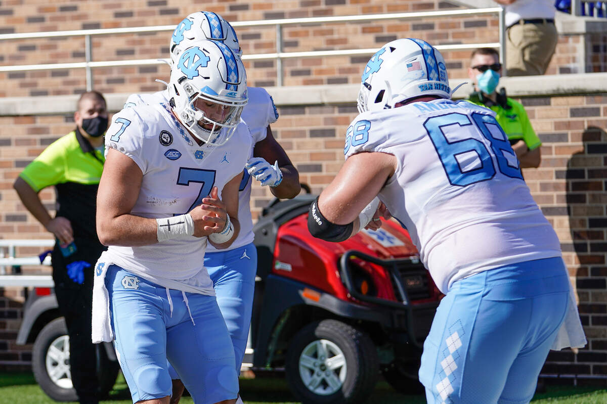 North Carolina Tar Heels quarterback Sam Howell (7) celebrates with lineman Brian Anderson (68) during the first quarter at Wallace Wade Stadium. 