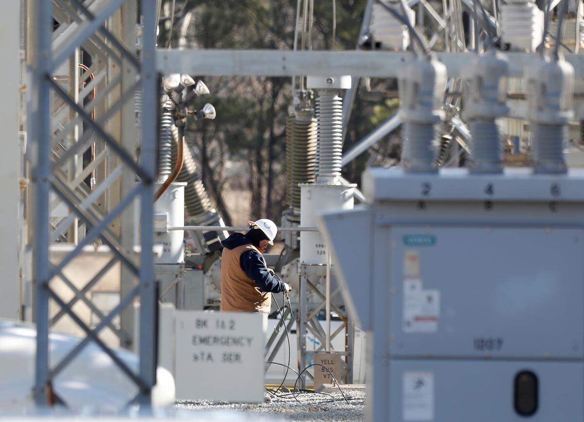 Crews work at an energy substation on Thursday, Jan. 18, 2024, in Durham, N.C. where an equipment failure during maintenance work on Wednesday caused a power outage to about 11,500 Duke Energy customers.