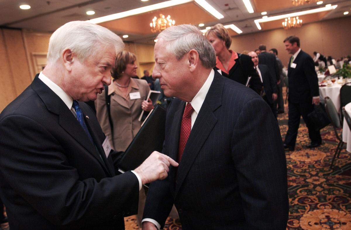 In a 2004 file photo, former Governor James B. Hunt Jr., left, talks with Raymond Gilmartin, President, CEO and Chairman of the Board of Merck & Co., after Gilmartin spoke at luncheon sponsored by the Institute for Emerging Issues at the North Raleigh Hilton.
