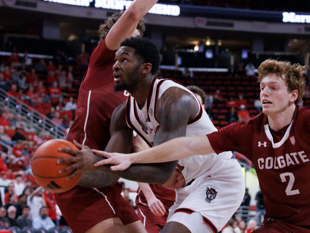 N.C. State’s Brandon Huntley-Hatfield drives to the basket past Colgate’s Blake Forrest during the second half of the Wolfpack’s 72-49 win at Lenovo Center on Monday, Nov. 18, 2024, in Raleigh, N.C.